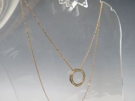 A HALLMARKED 9CT GOLD CIRCULAR CHANNEL SET DIAMOND PENDANT, on a gilt 925 silver chain