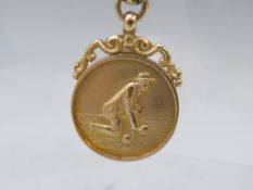 A HALLMARKED 9CT GOLD BOWLS MEDAL, suspended on a 9ct gold belcher chain, approx combined weight