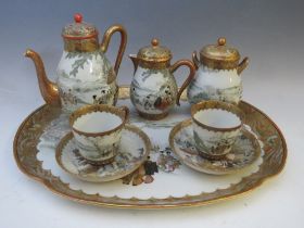 A VINTAGE KUTANI / SATSUMA CERAMIC HAND PAINTED TEA SET ON TRAY, with two cups and saucers, one A/F
