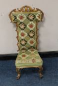 A VICTORIAN MAHOGANY CARVED PRAYER CHAIR, with floral needlepoint upholstery