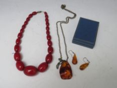 A SINGLE STRAND CHERRY AMBER BEAD NECKLACE, together with a boxed amber pendant and earrings