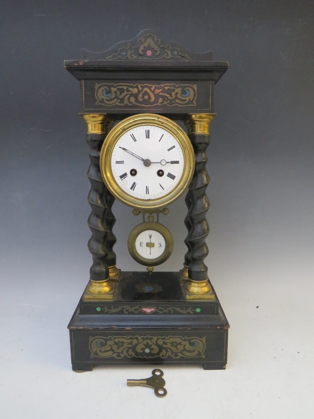 A LATE 19TH CENTURY PORTICO CLOCK, having a black ebonised frame with various boule embellishment