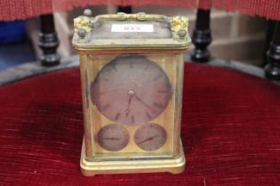 A LARGE GILDED TRAVEL ALARM CARRIAGE CLOCK, having three silvered subsidiary dials, the lower two