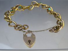 A 15CT GOLD FANCY LINK BRACELET, with turquoise and seed pearl embellishment, stamped to heart