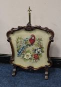 A VICTORIAN MAHOGANY FRAMED SCREEN, with inset needlepoint floral and parrot detail, on a reduced