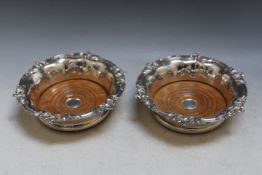 A PAIR OF ORNATE SILVER PLATED WINE BOTTLE COASTERS, Dia 18 cm