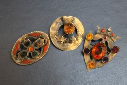 THREE SCOTTISH THEMED BROOCHES, consisting of an oval hardstone example set in hallmarked silver (