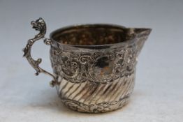 A HALLMARKED SILVER CREAM JUG- LONDON 1894, with mythical animal handles, approx weight 65g, W 10