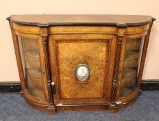 A VICTORIAN WALNUT CROSSBANDED CREDENZA, the single panelled door with a continental oval