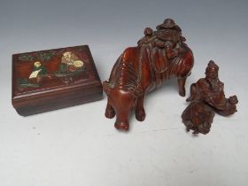 AN EASTERN CARVED WOODEN WATER BUFFALO, L 18.5 cm, together with a smaller carved Eastern