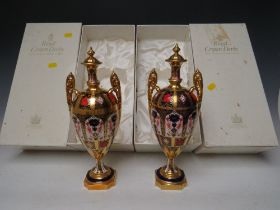 A PAIR OF BOXED ROYAL CROWN DERBY OLD IMARI PATTERN TWIN HANDLED LIDDED VASES / URNS, pattern no.