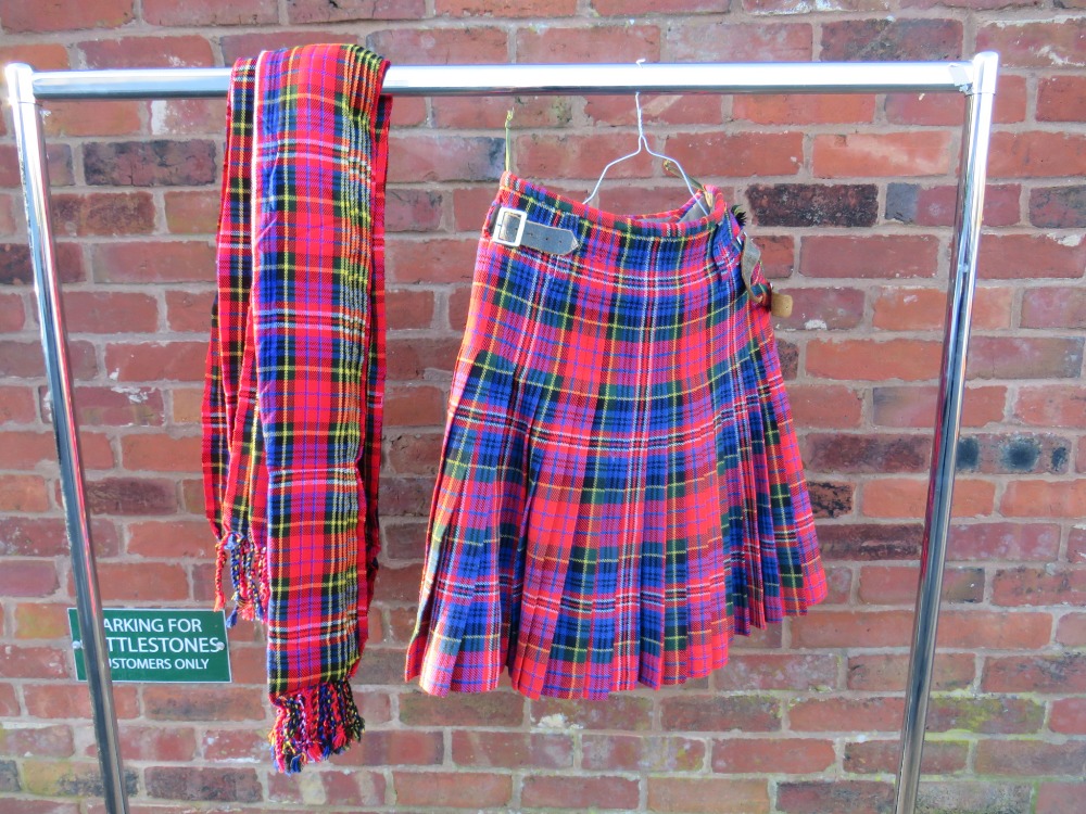 A TARTAN MILITARY KILT TOGETHER WITH A TARTAN PIPERS PLAID