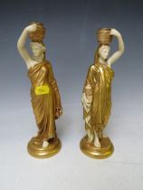 A PAIR OF ROYAL WORCESTER DRAPED MAIDEN FIGURINES HOLDING PITCHER AND JAR, in gold / white, H 24.5