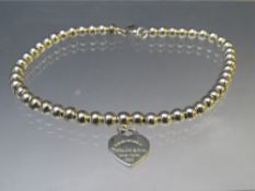 A TIFFANY & Co. 925 SILVER BEAD BRACELET WITH HEART SHAPED TAG, approximately 5.6 g