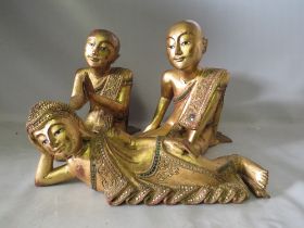 THREE EARLY GILDED WOODEN BUDDHA STATUETTES, two kneeling, one recumbent, kneeling Buddha H 33 cm,