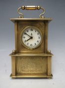 A SMALL BRASS CASED MUSICAL ALARM CLOCK, playing Brahms 'Lullaby For Babies'