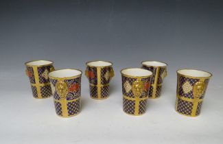 SIX CAVERSWALL IMARI ROMANY PATTERN BEAKERS WITH LION HEAD HANDLES, having 22ct gold gilding