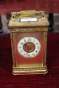 A LARGE ORNATE GONG STRIKE REPEATER CARRIAGE CLOCK, the gilded case having floral cast embellishment