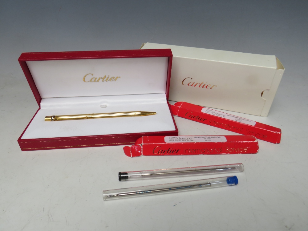 A BOXED CARTIER 'TRINITY' STYLE GOLD PLATED BALLPOINT PEN, together with two refills (unchecked)