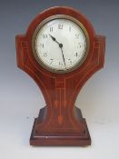 AN EDWARDIAN MAHOGANY AND INLAID MANTLE CLOCK, with French movement, standing on four small gilt bun