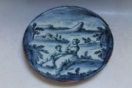 AN ITALIAN STYLE TIN GLAZE FOOTED DISH WITH PORTRAIT OF MOTHER AND CHILD IN A TYPICAL COUNTRY SCENE,