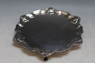 A HALLMARKED SILVER SALVER - LONDON 1896, on three pad feet, pie crust border and three armorial