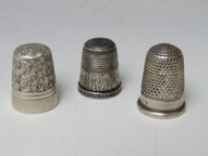 A CHARLES HORNER WHITE METAL THIMBLE, together with a Charles Horner hallmarked silver thimble and a