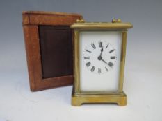 A SMALL FRENCH BRASS CARRIAGE CLOCK, held in a red Moroccan leather travelling case, with Key, H