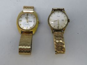 TWO VINTAGE WRIST WATCHES, comprising a Kienzle day / date watch, together with a Mudu day / date