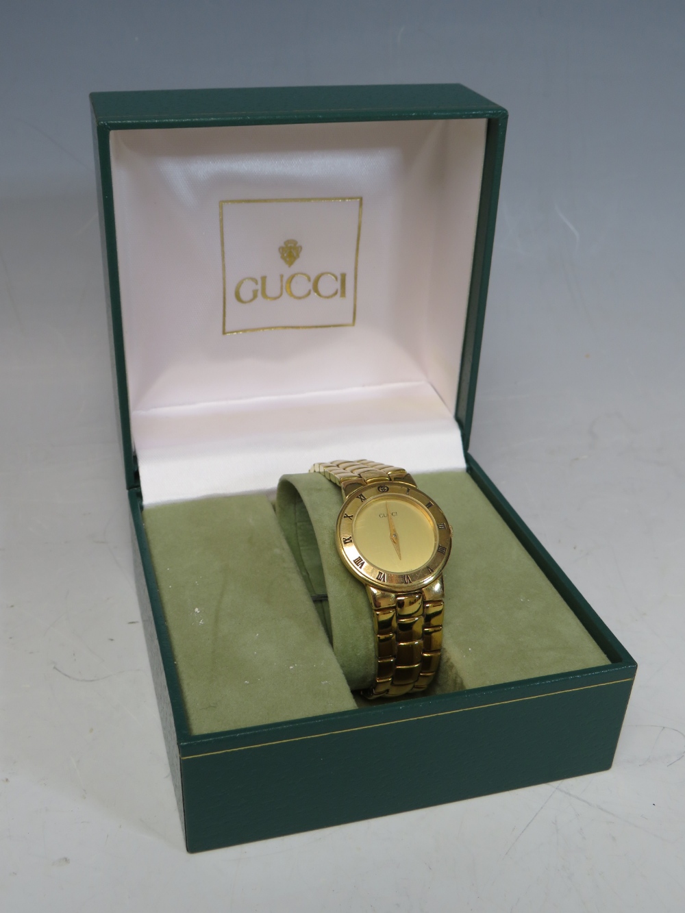 A 1980 / 90'S LADIES GUCCI GOLD PLATED WRISTWATCH, with champagne coloured dial and Roman Numerals