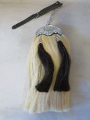 A HORSE HAIR SPORRAN WITH THISTLE EMBELLISHMENT