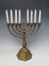 A BRASS EIGHT BRANCH MENORAH CANDLESTICK, raised on an octagonal base, H 24 cm