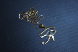 AN EGYPTIAN STYLE PENDANT, with continental marks, on a box chain stamped 750, approx combined