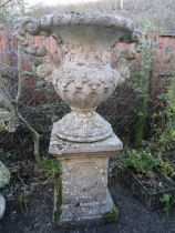 AN UNUSUAL FIBREGLASS ? CLAD TWIN HANDLED BALUSTER URN ON STAND, H 145 cm