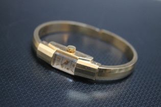 A CONTINENTAL 585 GOLD CLASP BANGLE WRIST WATCH, approx weight 17.1g, W 1 cmCondition Report:ticks