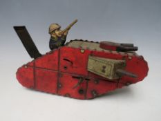 A VINTAGE TINPLATE CLOCKWORK FIRST WORLD WAR TANK, with figure inside, L 24 cm