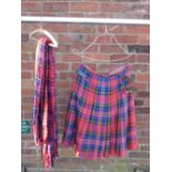 A TARTAN MILITARY KILT TOGETHER WITH A TARTAN PIPERS PLAID