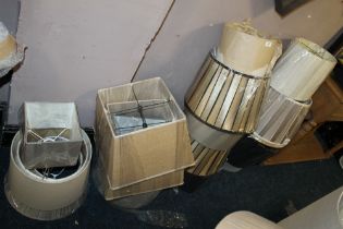A LARGE QUANTITY OF ASSORTED LAMP / LIGHT SHADES - ( AGAINST WALL)