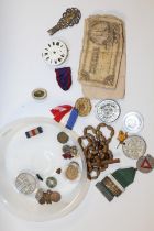 A TUB OF ASSORTED MEDALS, BADGES AND COLLECTABLES