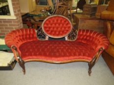 A ANTIQUE MAHOGANY CARVED UPHOLSTERED SHAPED SETTEE