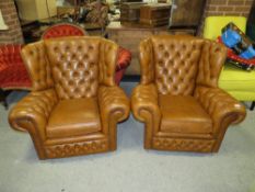 A PAIR OF BROWN UPHOLSTERED CLUB STYLE ARMCHAIRS