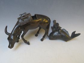 A BRONZE ORIENTAL CENSOR, modelled as an ox with removable saddle, L 22 cm, together with a Buddha