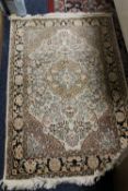 A SMALL EASTERN SILK RUG 75 X 115 CM