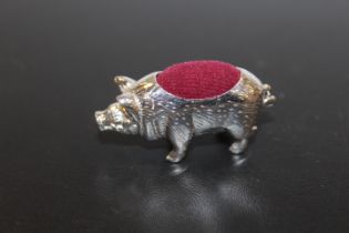 A SILVER PIG PIN CUSHION