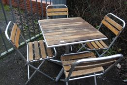 AN ALUMINIUM / HARDWOOD CAFE STYLE PATIO / GARDEN TABLE SET WITH FOUR FOLDING CHAIRS