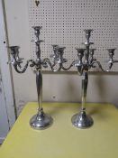A PAIR OF POLISHED METAL CANDELABRA