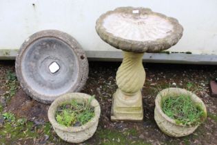 A SHELL DESIGN CONCRETE BIRD BATH, TWO PLANTERS AND A BIRD BATH TOP DISH