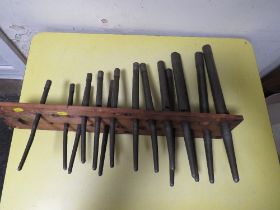 A UNUSUAL SET OF GRADUATING MUSICAL PIPES IN A HOLDER