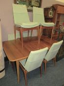 A RETRO TEAK EXTENDING DINING TABLE WITH ONE LEAF AND SIX CHAIRS