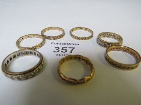 SEVEN 9CT GOLD ETERNITY RINGS, - SOME MISSING STONES, APPROX W 15.7 G